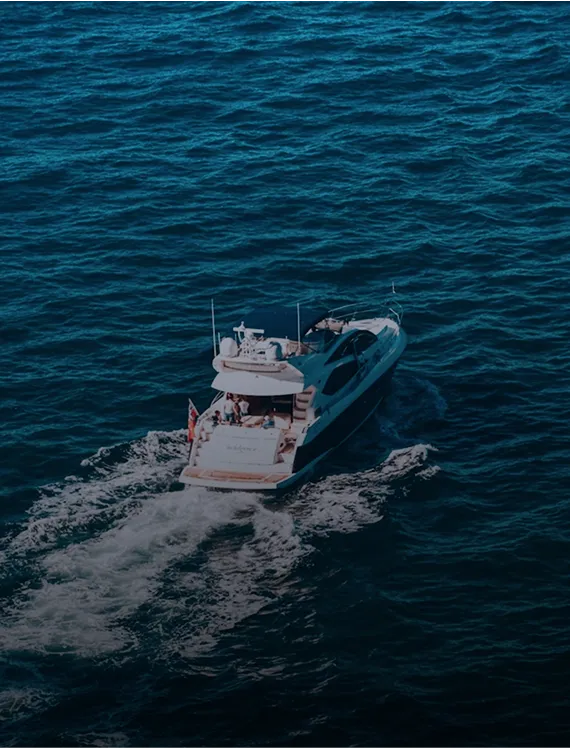 Motor yacht cutting through deep blue open water