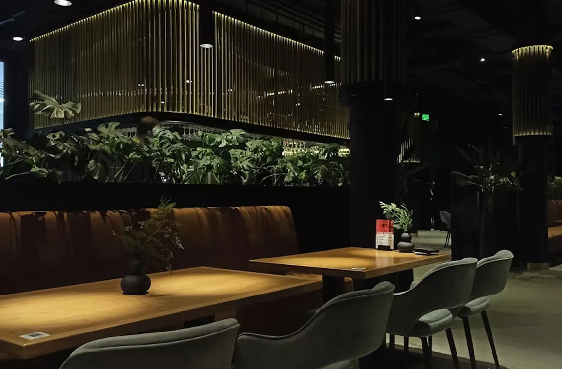 Warmly lit interior of a refined restaurant with velvet seating