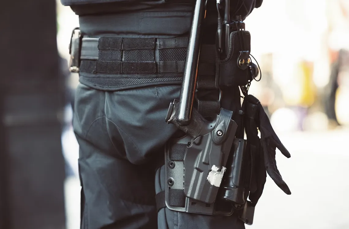 Close-protection professional in tactical gear, photographed discreetly