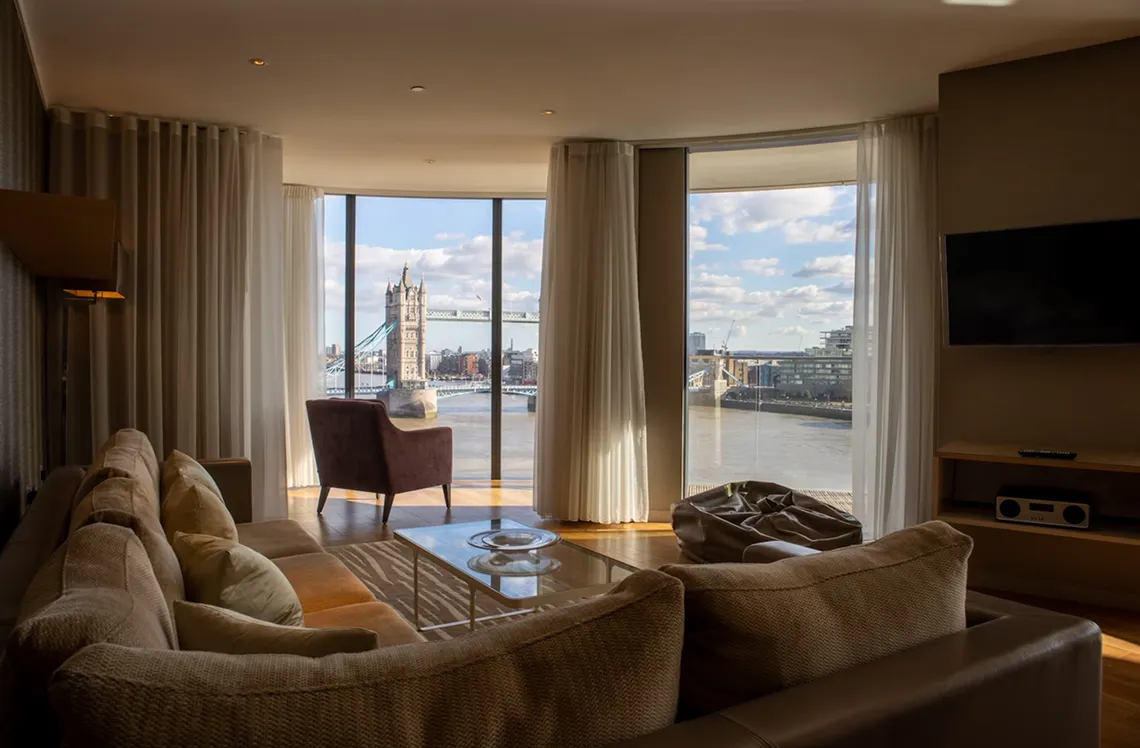 Luxury riverside suite with panoramic windows overlooking Tower Bridge
